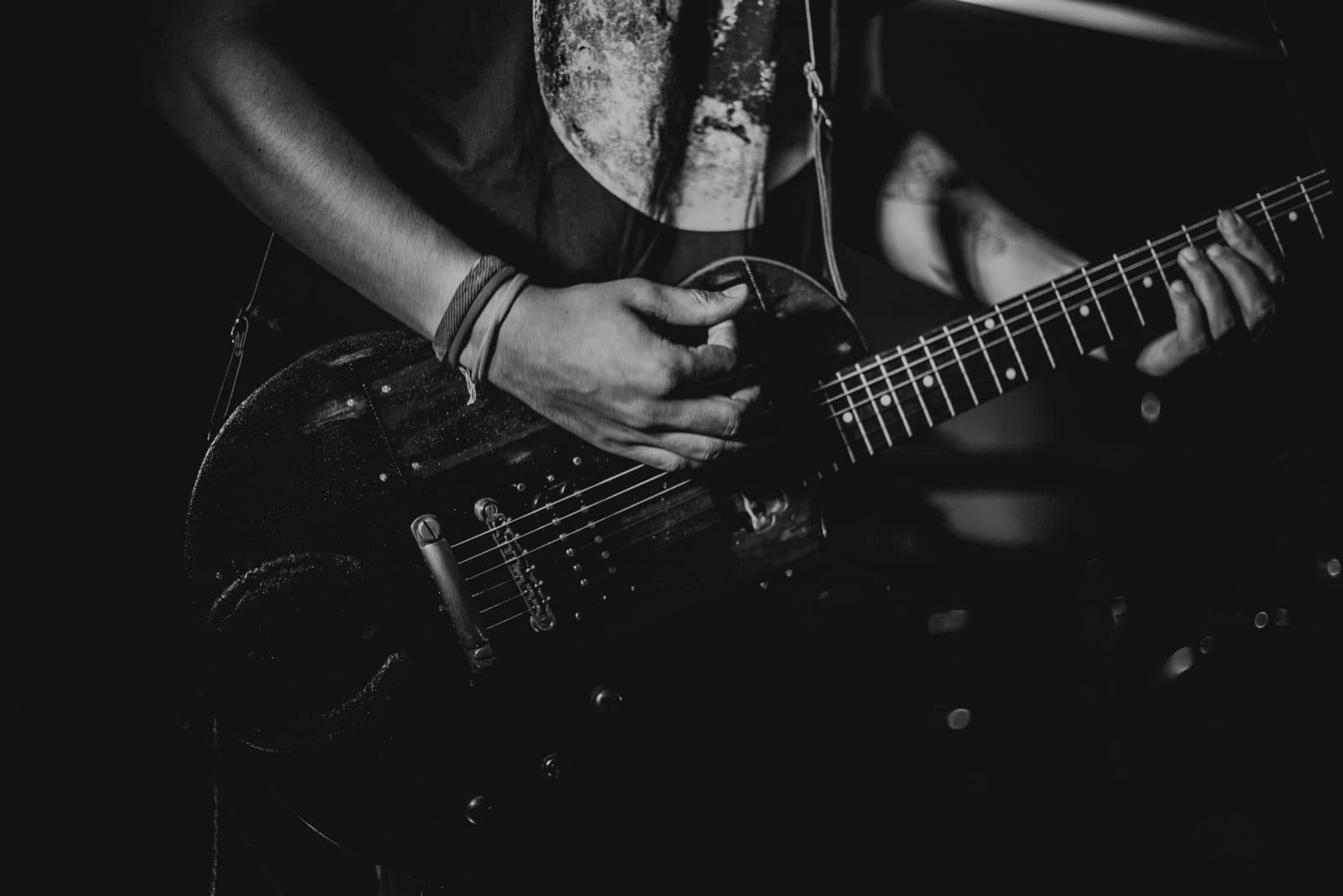Guitariste jouant de la guitare électrique en noir et blanc