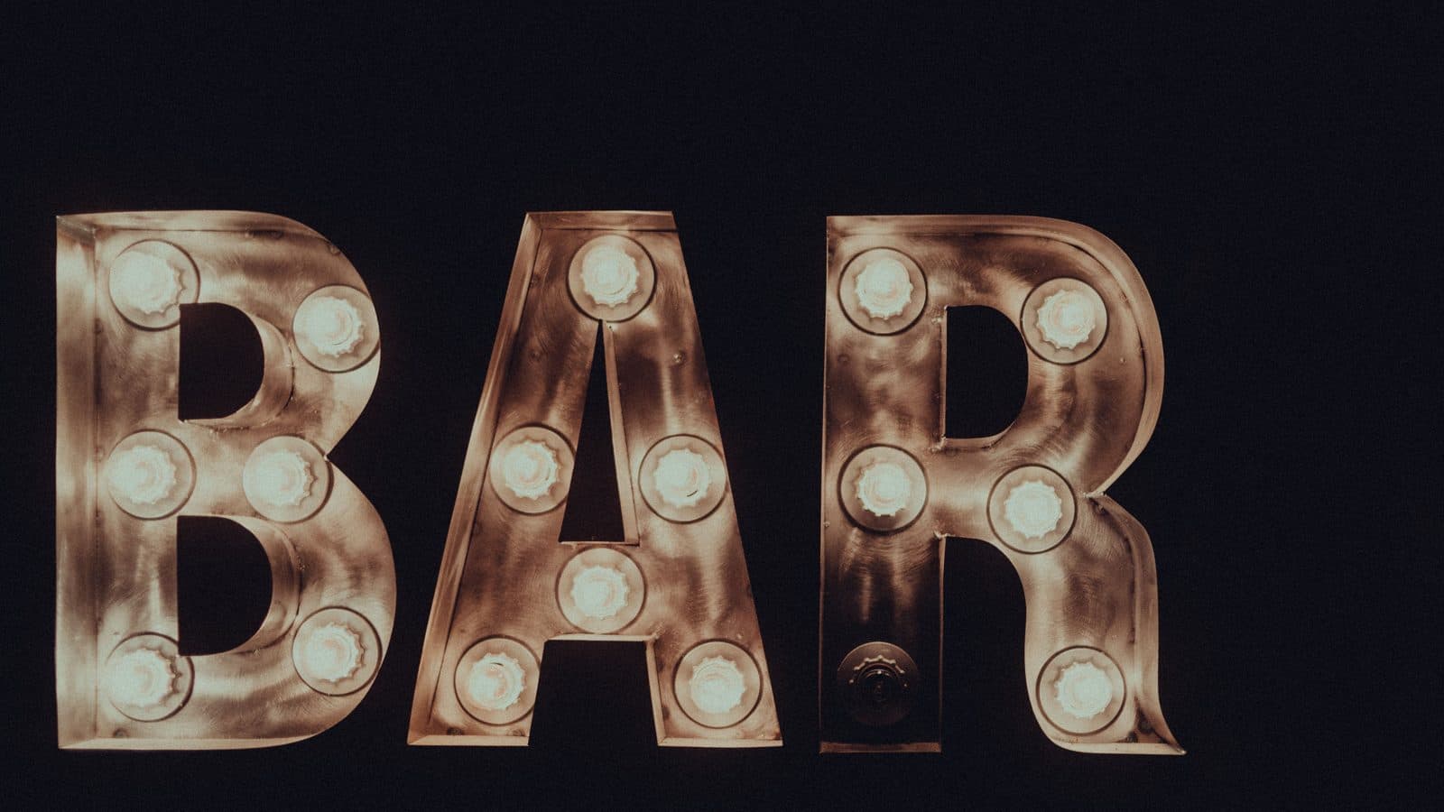 Marquee light-up letters spelling BAR