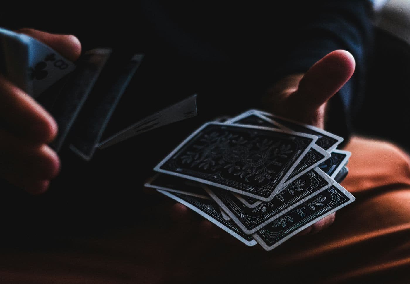 A magician's hands handling a deck of cards in close-up