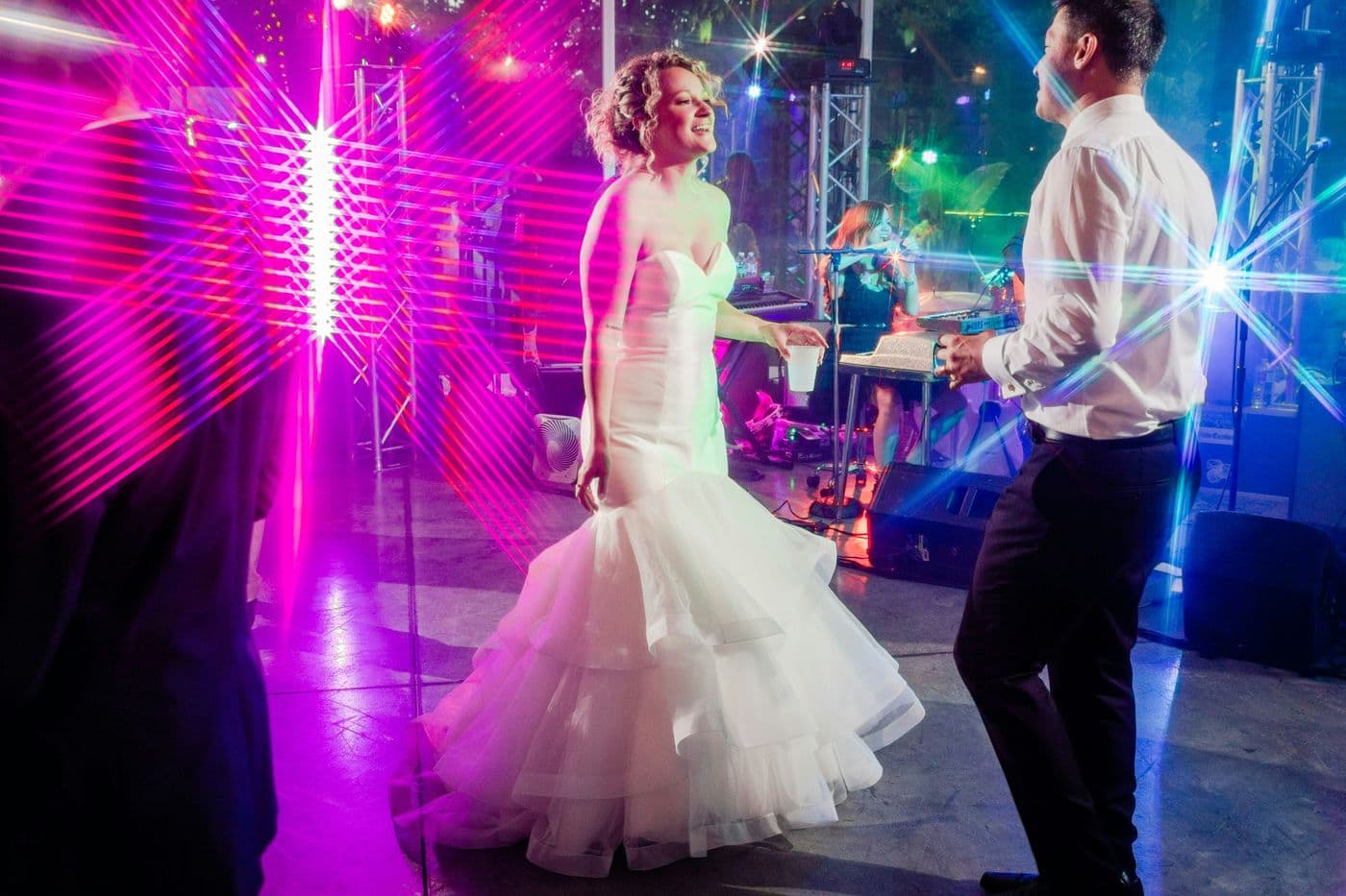 Bride and groom dancing in front of a live band
