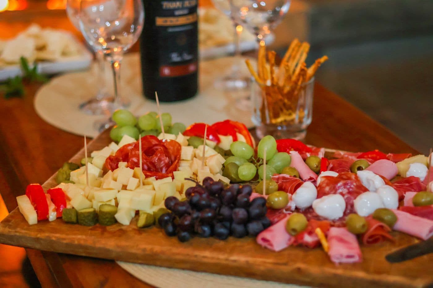 Grazing board with cured meats, cheese, grapes and olives